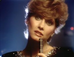 Olivia Newton-John performs Love Make Me Strong on Physcial videogram